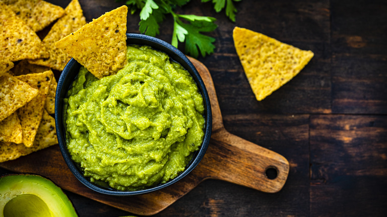A bowl of guacamole and chips