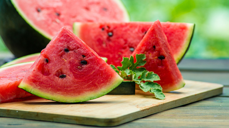 Watermelon triangles on chopping board