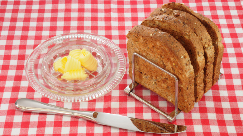 Bread on toast rack with knife and butter dish