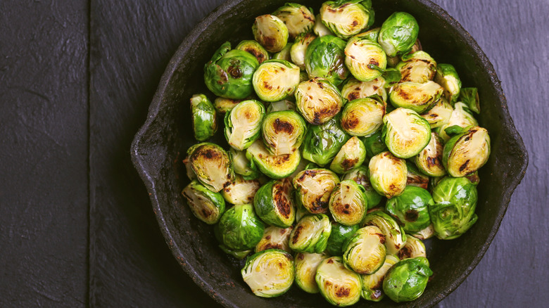 Fried brussels sprouts in a cast iron pan