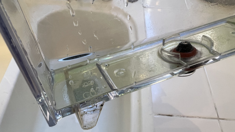 A person refills a Nespresso water canister