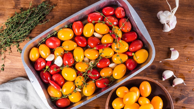 cherry tomatoes in a baking pan with oil
