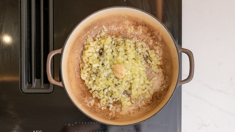 pan containing garlic paste and cooked diced onions