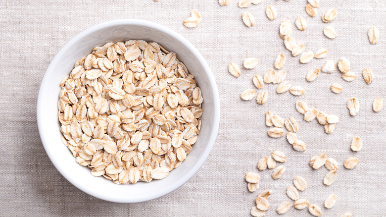 Bowl of oats and scattered oats