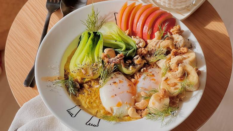 Bowl of oatmeal with vegetables, egg