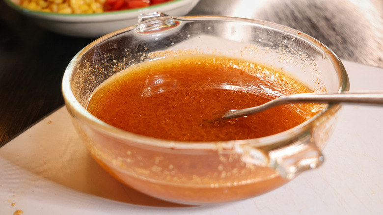 reddish vinaigrette in small glass bowl with fork