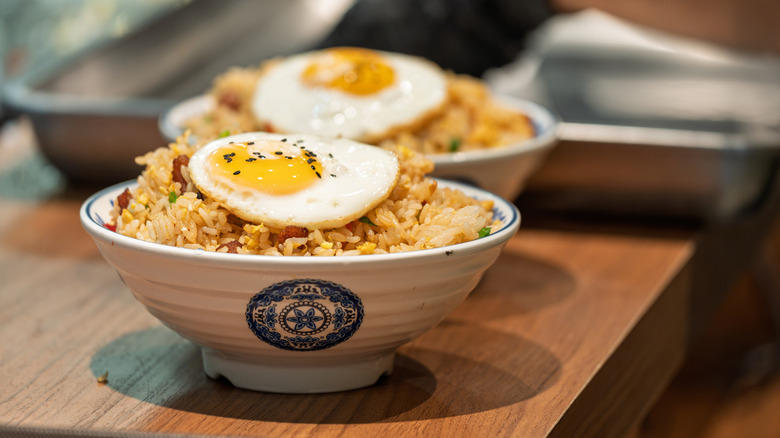 Fried eggs over fried rice
