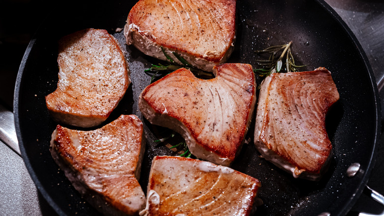 Tuna steaks searing in pan