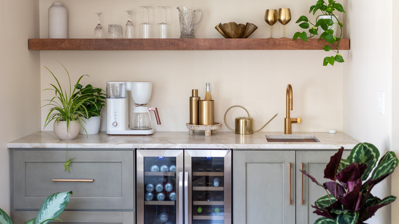 kitchen with gray cabinets, copper fixtures, wooden designs, and plants