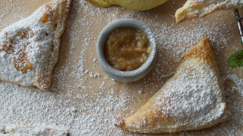 Apple turnovers with applesauce and powdered sugar