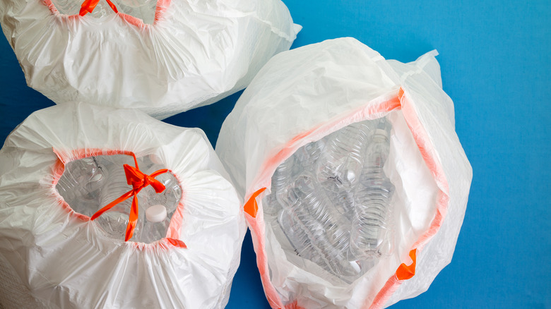 trash bags full of empty plastic water bottles