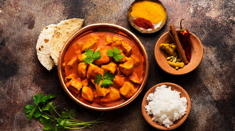 Chicken tikka masala with rice, spices, and naan bread