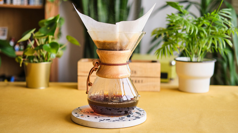 A Chemex brewing coffee with a filter in it
