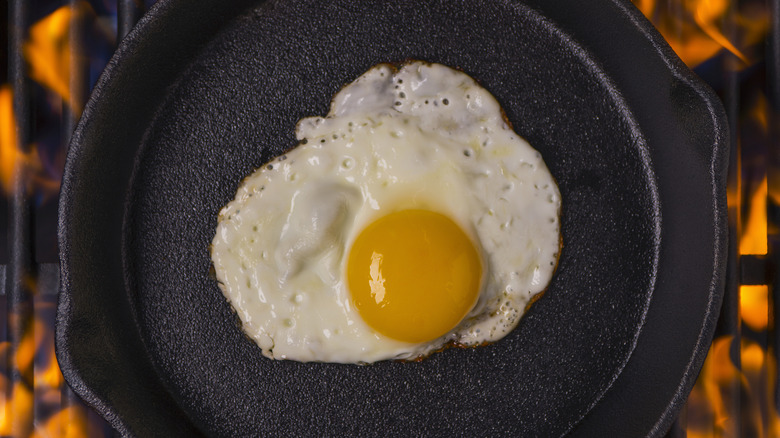 An egg in a skillet over grill