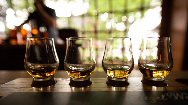 four snifters with bourbon pours