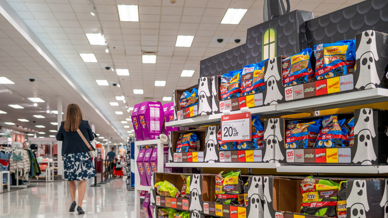 A person shops for Halloween candy at Target amid last-minute discounts