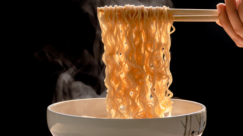 Steaming ramen noodles on chopsticks