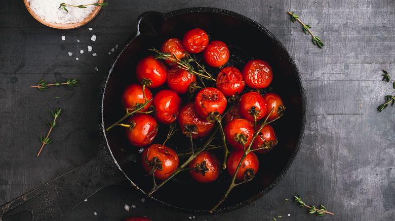 Roasted tomatoes on the vine in a cast iron skillet
