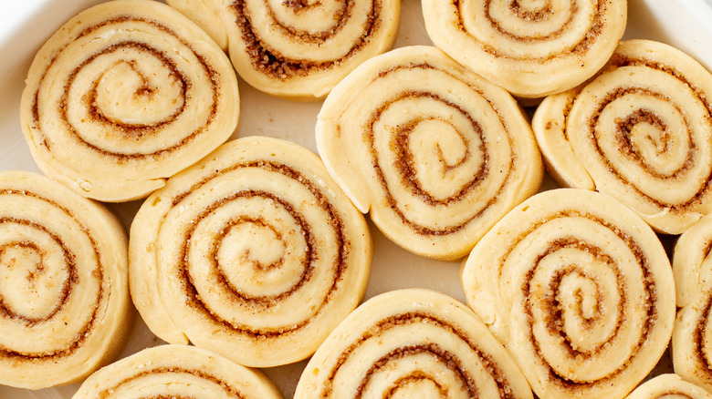 Raw cinnamon rolls in a pan