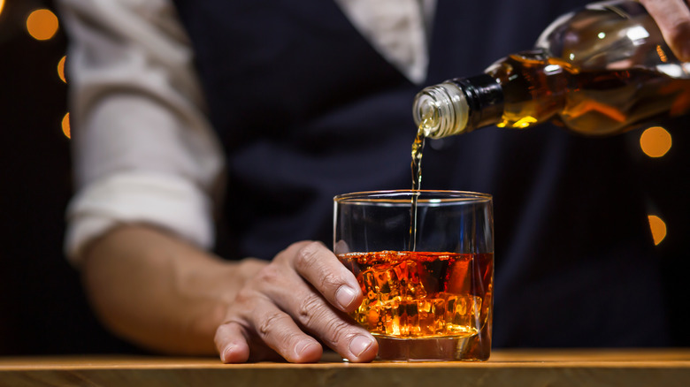 bartender pouring bourbon