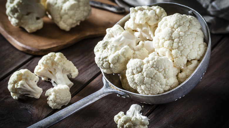 Pieces of cauliflower in a metal strainer