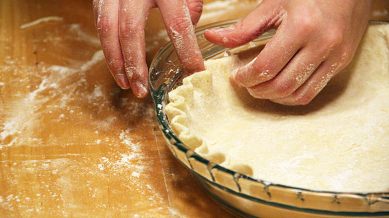 person crimping a pie crust