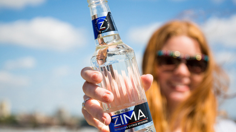 woman holding bottle of zima