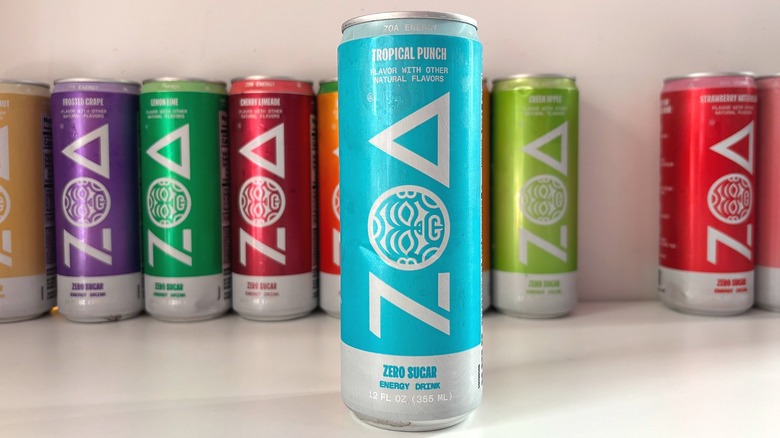 Can of Tropical Punch ZOA energy drink on white table, other cans behind