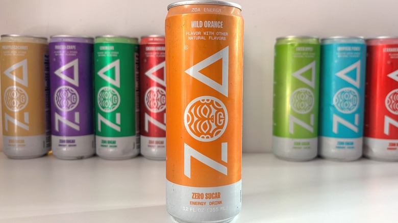 Can of Wild Orange ZOA energy drink on white table, other cans behind